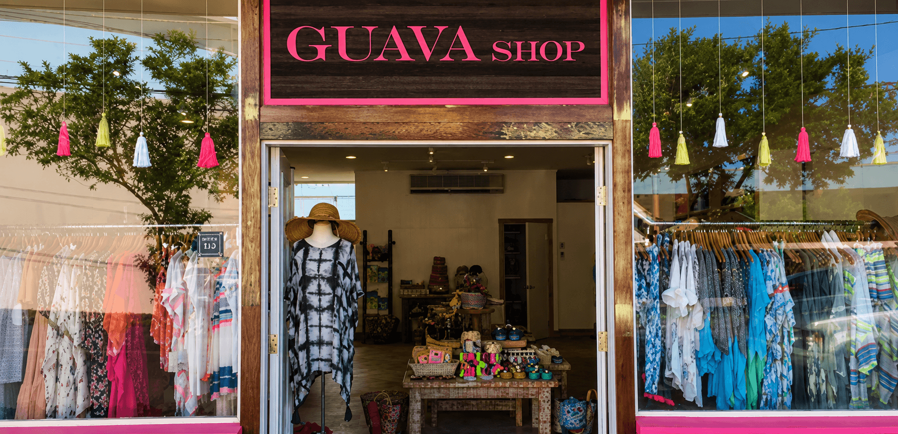 Guava Shop's Haleʻiwa storefront entrance with clothing racks on display