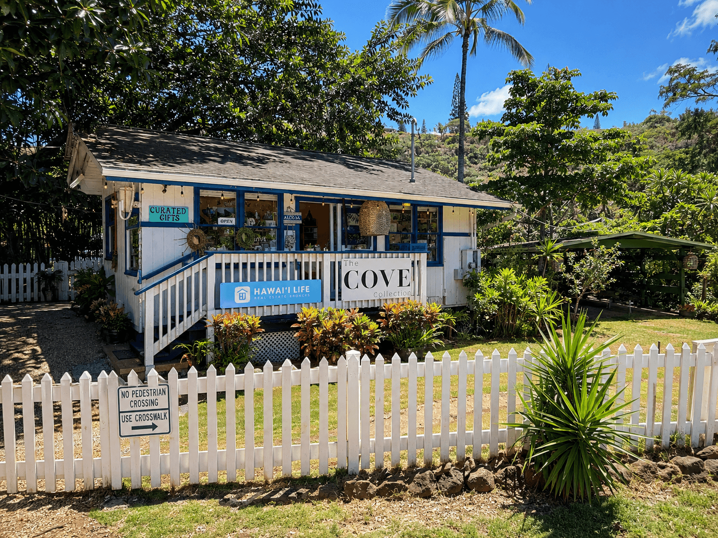 The Cove Collection's cottage storefront with its porch sign
